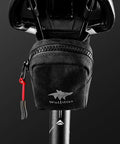 Compact under seat cycling saddle bag for road bikes with easy access zipper, durable and water resistant material.