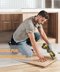 Oscillating multitool side view with yellow and black housing cutting a wooden panel.