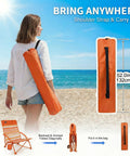 Woman carrying orange bag for Two Pack Low Beach Chairs For Adults Folding Recliner Camping Chairs on a beach.