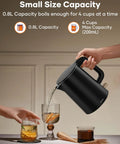 Tiny But Mighty 0.8L Electric Kettle With 1000W Fast Boil pouring water into glasses on a table, black, ideal for small spaces