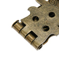 Close-up of antique bronze latch lock with carved flower pattern for wooden boxes and chests, old school toggle clasp detail
