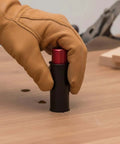Gloved hand adjusting Retractable Table Stop for Woodworking Benches, Rock Solid Bench Dog That Fits Standard Holes, 20mm Diameter