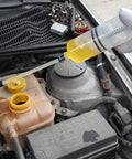 No Fuss Heavy Duty 500cc Car Fluid Extractor Pump With Flexible Hose draining fluid from a car engine's reservoir.