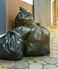 95 To 100 Gallon Heavy Duty Trash Bags Mega Value 50 Bags With Ties Black Extra Large Garbage Bags on sidewalk