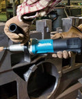 Heavy Duty Quarter Inch Sjs Die Grinder With Six Point Six Amp Motor Pushing Up To Twenty Eight Thousand Rpm Variable Speed Trigger being used on metal.