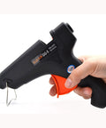 Hand holding Wax Sealing Glue Gun For 0.4 Inch Sticks, Quick Heat And Smokeless Melt, designed for crafts and letters.