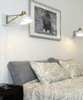 1 Light Plug In Or Hardwire Swing Arm Wall Sconce With White Finish Brass Accents White Cloth Cord Mounted Bedside Lamp in bedroom