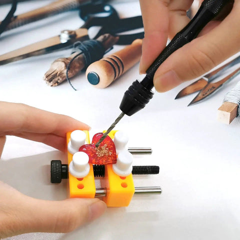 Person using Pin Vise Hand Drill Set With Bench Vise 0.5 To 3mm PCB Mini Twist Drill Bits on a small red object in a yellow vise