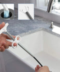 Flexible Sink Grabber Reacher Tool With Four Claws near a kitchen sink, illustrating grip and use in drain cleaning.