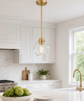 Two Pack Brass Pendant Lights With Clear Glass Globe Shades Farmhouse Gold Hanging Lamps For Kitchen Island Dining Room And Entryway, featuring a clear globe shade above a kitchen counter.