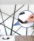 Black Painter Tape 1 Inch By 60 Yards creating geometric wall design, inset showing tape adhesion.