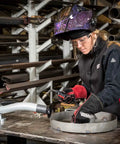 Woman wearing WoShadow Welding Jacket For Women With Female Fit Adjustable Side Straps Built For Ladies Fits Like A Glove Black And Red Medium US Durable Fire Resistant Shell Lightweight Comfort For Pro Welders And DIY Hobbyists in workshop