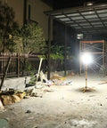 100W LED Tripod Work Light With Stand illuminating an outdoor construction site, showcasing 360 Degree Coverage and Durable Construction.