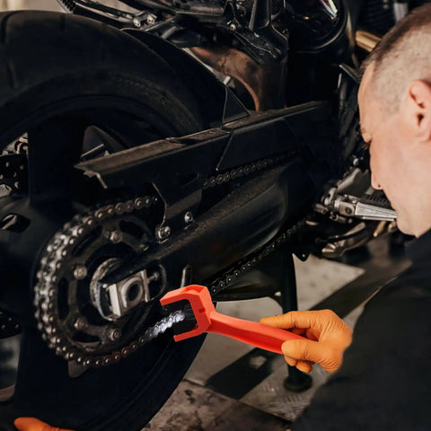 Person using Chain Cleaning Brush For Motorcycles And ATVs Universal Bicycle Chain Cleaner Tool Durable Nylon Bristles And ABS Body