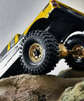 Black Label M/T 63mm by 21mm RC Tires on 1/24 crawler conquering rocky terrain, highlighting NL4 competition compound.