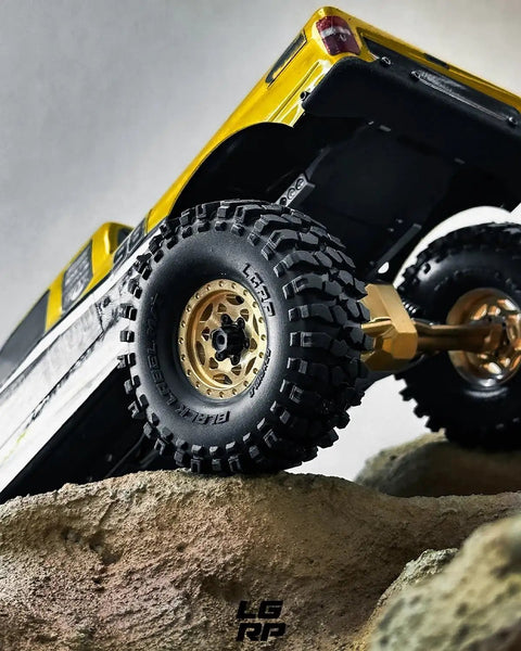 Black Label M/T 63mm by 21mm RC Tires on 1/24 crawler conquering rocky terrain, highlighting NL4 competition compound.
