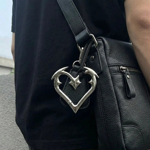 Y2K Heart Carabiner Keychain With Cute Star Clip attached to a black bag, showing durable metal goth style, trendy accessory.