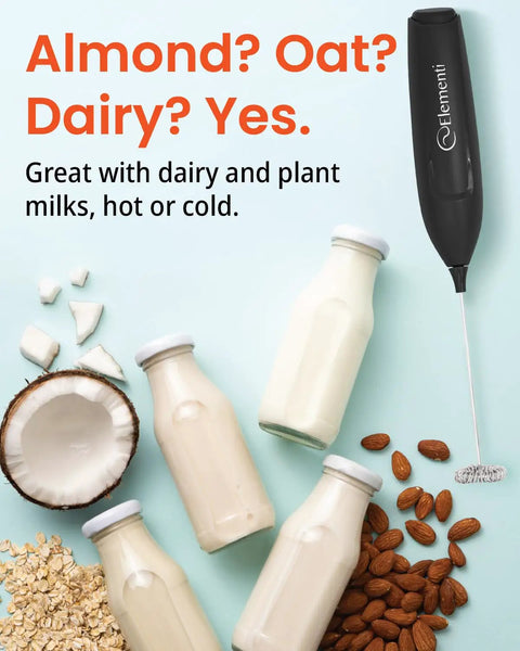 Kickass Barista Grade Milk Frother Wand Handheld Drink Mixer for lattes and cappuccinos beside almond, oat, and dairy milk bottles.