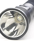 Close-up of the lens and LED bulb of an 800 Lumen Rechargeable LED Flashlight With Dual Switches, 438 Meter Beam, Black.