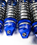Close-up of four Blue Aluminum BigBore Shocks For 4x4 And 2WD Trucks And SUVs Front And Rear Adjustable High Performance.