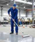 Worker using Three Piece Spiked Roller Set Pro Grade For Self Leveling And Epoxy Floors Includes 6 Inch 9 Inch And 20 Inch Heads Removable