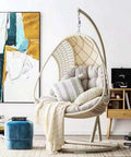 Beefy Heavy Duty Spring Hammock Chair With 700Lb Capacity Suspension Swing Hanger For Porch Patio And Garden Fits Almost All Hammock Chairs And Swing Benches Galvanized Steel Coil with cushions in a living room setting.