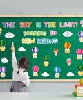 3D Hot Air Balloon Honeycomb Bulletin Board Set For Classroom Decor with colorful balloon cutouts and cloud shapes displayed.