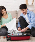 Couple using 102 Piece Reusable Hook And Loop Cable Ties Set to organize cables in a suitcase for travel.