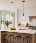 Slick Polished Brass Pendant Light Cord Kit With Heavy Duty Braided Textile Wire And Secure E26 Lamp Base over kitchen island.
