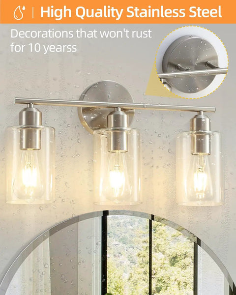 Three Light Bathroom Vanity Light Fixture In Brushed Nickel With Clear Glass Shades Over Mirror Wall Sconce No Fuss Easy To Install