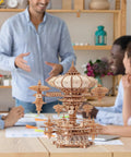 3D Wooden Puzzle Kit for Adults With SkyCity Cityscape, 600 Plus Pieces, Mind Blowing Mechanical DIY Craft That Doubles as a Music Box, Perfect STEM Toy Gift for Puzzle Fans and All Occasions, assembled wooden cityscape on table