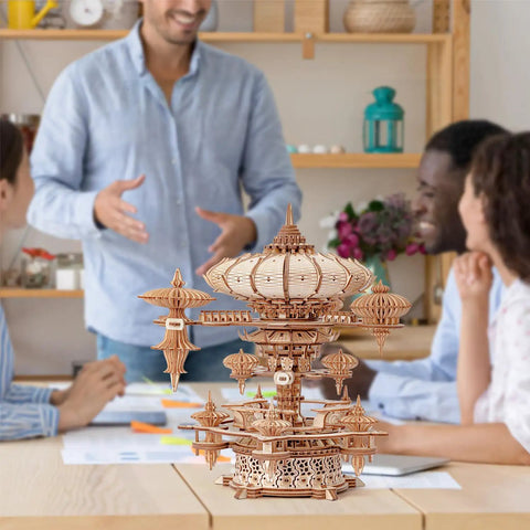 3D Wooden Puzzle Kit for Adults With SkyCity Cityscape, 600 Plus Pieces, Mind Blowing Mechanical DIY Craft That Doubles as a Music Box, Perfect STEM Toy Gift for Puzzle Fans and All Occasions, assembled wooden cityscape on table