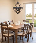 Dining room with table and Capistrano 28 Inch Six Light Rustic Farmhouse Chandelier With Antique White Finish And Galvanized Steel Accents