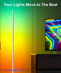 Smart RGB Corner Floor Lamp With App And Remote, 16 Million Colors, next to a TV with vibrant LED display in a modern living room.