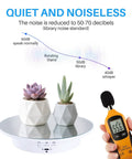 Hassle Free Rotating Display Turntable Stand For Jewelry And Watches 7.87 Inch White platform with potted plants, measuring sound levels.