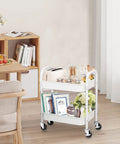 Durable 2 Tier Metal Rolling Cart With Handle And Locking Wheels White in living room with books and decor
