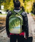 Sunlit Seaside Botanical Print Unisex Backpack on a person walking through a park