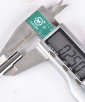 Close-up of SpeTool 1/4 in shank carbide end mill for aluminum, 3-flute, 3.5 in long, upcut CNC router bit in caliper