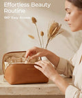 Woman organizing Go To Large Makeup Bag Travel Cosmetic Organizer In PU Leather Flat Open Toiletry Case For Women, classic brown finish.