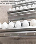 Smooth Rolling Gravity Roller Conveyor With Abs Plastic Wheels And Precision Bearings Unpowered Flow Track close-up of white ABS rollers.