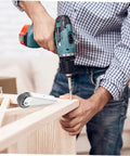 Man using a drill to install Smooth As Butter 2 Pack Nylon Galvanized Barn Door Rollers on wooden furniture.