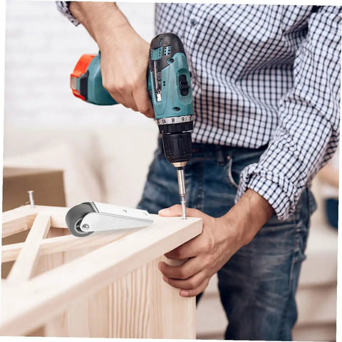 Man using a drill to install Smooth As Butter 2 Pack Nylon Galvanized Barn Door Rollers on wooden furniture.