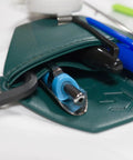 Close-up of spruce green faux leather pocket protector holding pens and tools for lab coats, ideal for scientists and engineers.