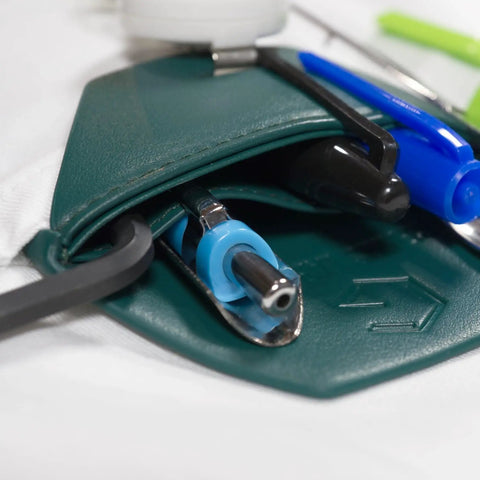 Close-up of spruce green faux leather pocket protector holding pens and tools for lab coats, ideal for scientists and engineers.