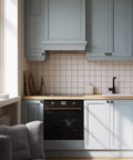 Modern kitchen with blue cabinets featuring 10 Pack Matte Black Cabinet Knobs, 1.2 Inch Round Drawer Knobs For Kitchen Cabinets.