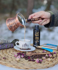 Pouring coffee from Handmade Copper Turkish Coffee Pot Gift Set For Four Cups 12 Oz Cezve Ibrik With Tinned Interior Engraved Solid Copper