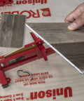 DIY Ready Laminate And Vinyl Plank Cutter For 8 Inch Boards in use cutting laminate, featuring zinc-plated steel blade for clean cuts.