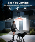 Woman walking dog in front of house at night under activated Beefy Three Head Solar Motion Sensor Flood Light Outdoor Waterproof 3000 Lumen 156 LED Security Spotlight For Patio Garage Yard Entryways Solar Powered 2 Pack Black