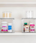 Four Pack Large Clear Stackable Storage Drawers With Smooth Pull Out Slides And Grippy Silicone Pads For Super Neat Closets That Keep Your Belongings Squared Away Daily holding vitamins and cotton swabs on a shelf.
