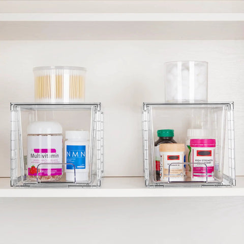 Four Pack Large Clear Stackable Storage Drawers With Smooth Pull Out Slides And Grippy Silicone Pads For Super Neat Closets That Keep Your Belongings Squared Away Daily holding vitamins and cotton swabs on a shelf.